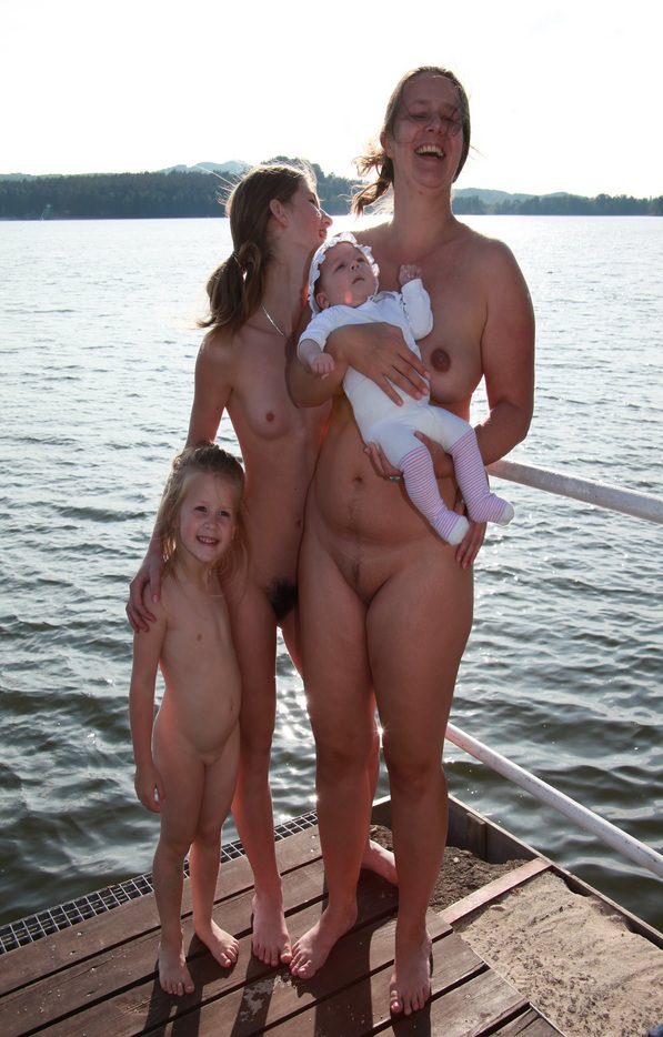 Mother and daughters nudists of a photo on the lake