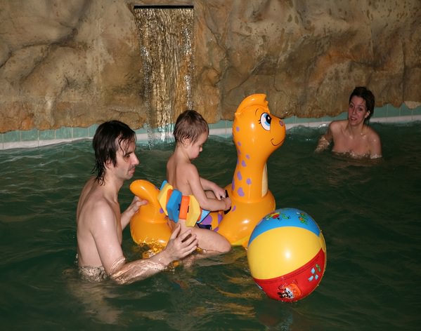 Nudists parents and young generation in a sauna