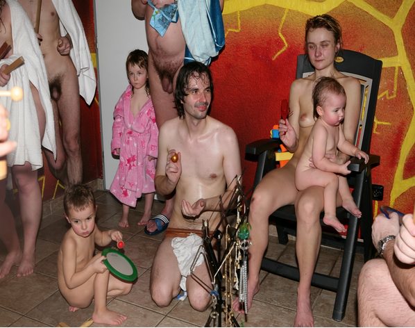 Nudists parents and young generation in a sauna