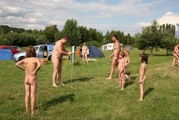 Naturista outdoors have a rest in the tent city