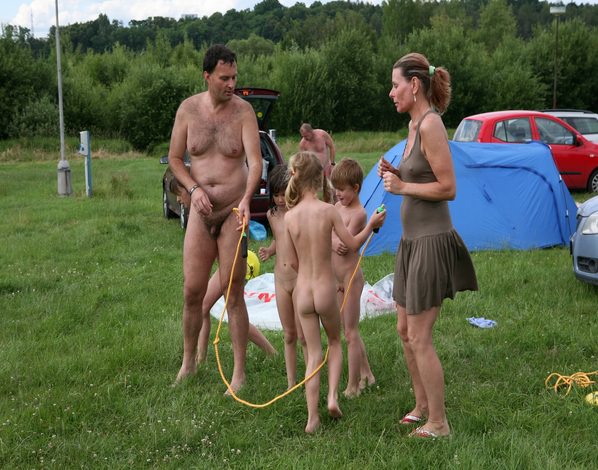 Naturista outdoors have a rest in the tent city