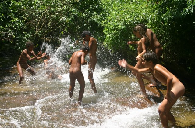 Young nudists of Brazil bathe in the mountain small river