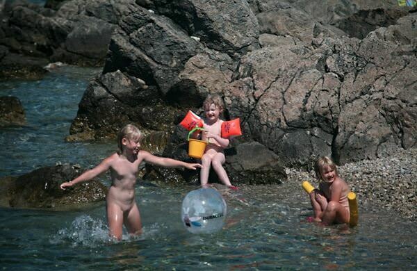 Nudists have a rest in a bay