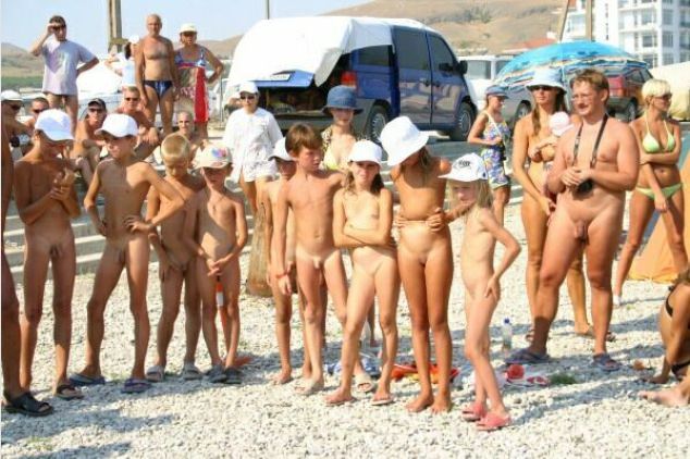 Meeting on a beach of families of nudists