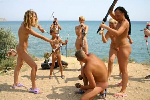 Nudists on a beach play Indians