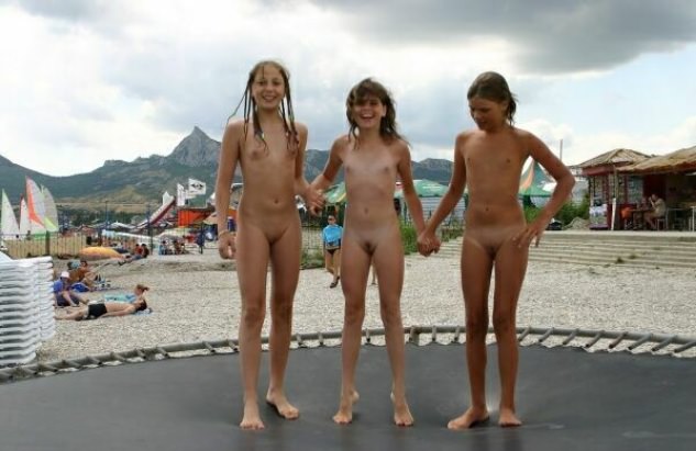 Family nudism - little girls nudists on a trampoline