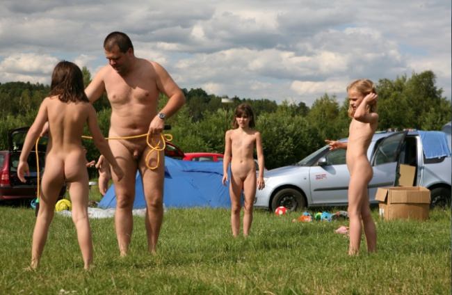 Family naturism - parents and children naturist bare outdoors